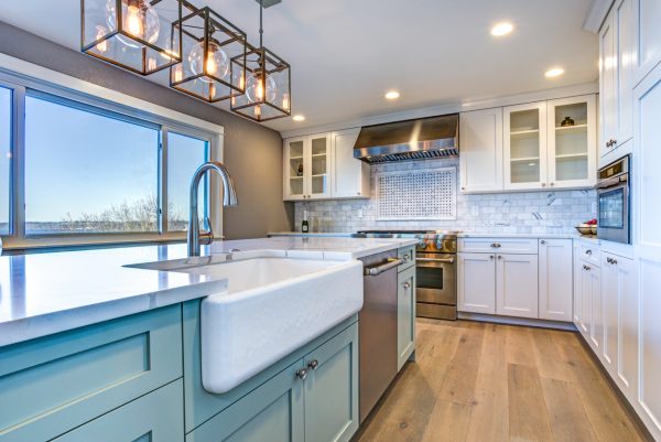 Waterfront kitchen renovation with farmhouse sink and turquoise island