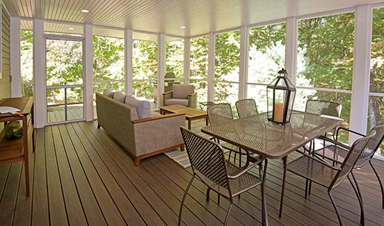 Furnished screened porch with white trim, paneled ceiling, and recessed lighting