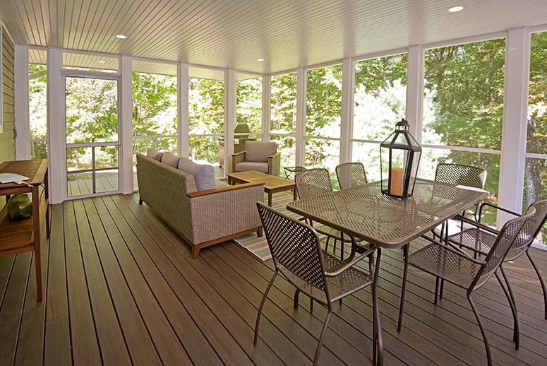 Furnished screened porch with white trim, paneled ceiling, and recessed lighting