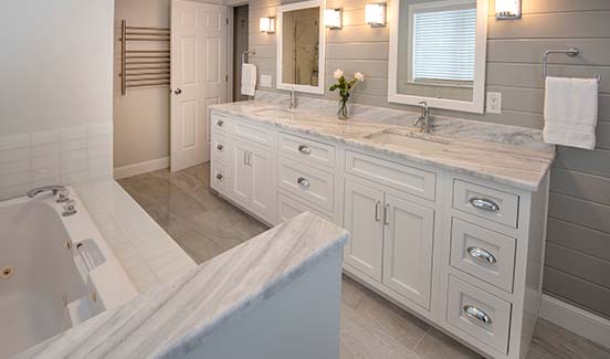 Grand marble white bathroom with double vanity sinks and bathtub