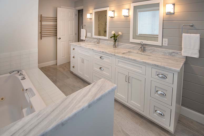 Grand marble white bathroom with double vanity sinks and bathtub