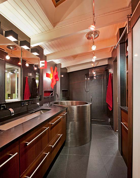 Bathroom with wooden cabinets and steel sink