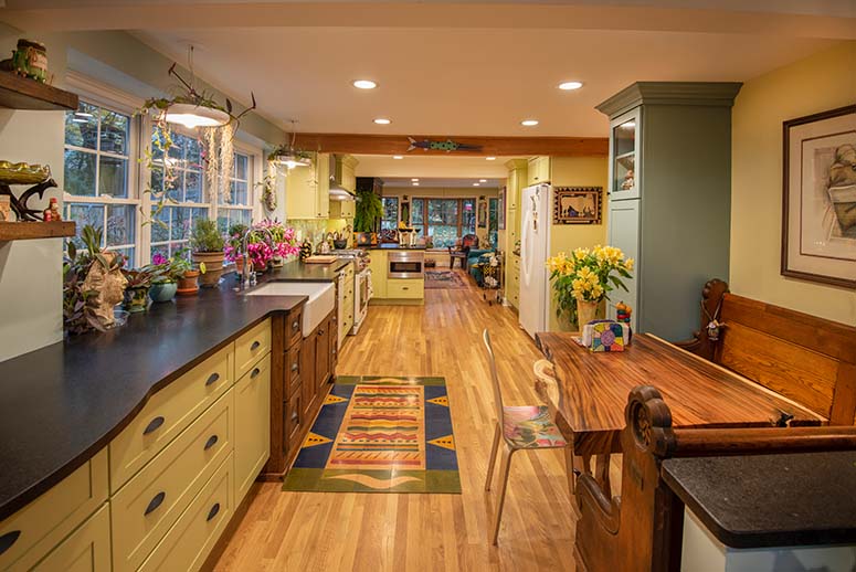 Colorful kitchen renovation with plants, wooden, pastel green and yellow accents