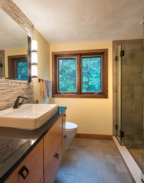 Bathroom remodel with mixed wood, stone, and granite materials