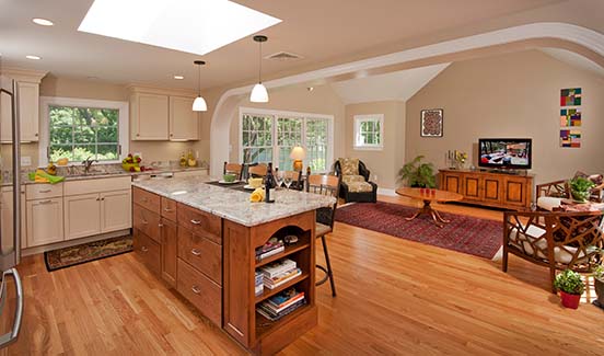 Kitchen with granite counters, white cabinets, and barstool chairs