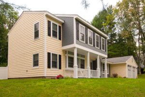 Outdoor view of two-story home with yard