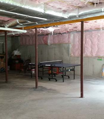 Unfinished basement with ping pong table