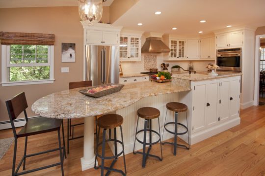 Kitchen remodel with extended island/seating and warm light brown tones