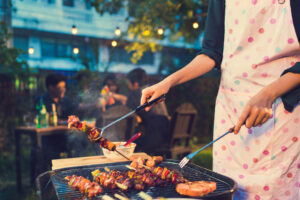 Person grilling outdoors in backyard